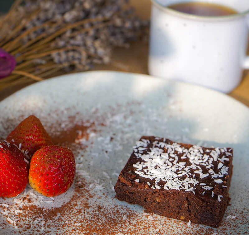 A dish of chocolate brownies with tea at breakfast, Dr. Cherine's healthy gluten-free recipe