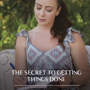 Photo of Dr. Cherine writing an e-book titled "The Secret to Getting Things Done" with passion.