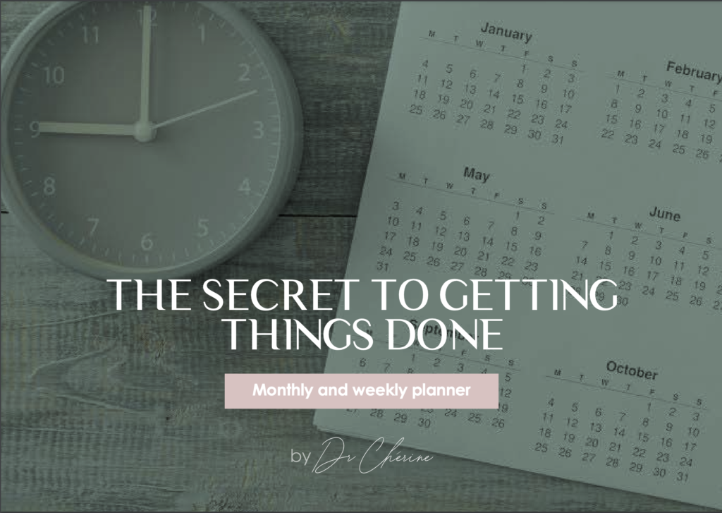 Photo of Dr. Cherine's printable weekly and monthly planner in english language for women, with the calendar and watch visible in the background.