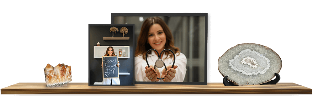 Wood shelf on it photo of Dr. Cherine making a heart shape from a stethoscope, and another photo where Dr. Cherine holds a quote written on a chalkboard, promoting personalized and precise preventive medicine